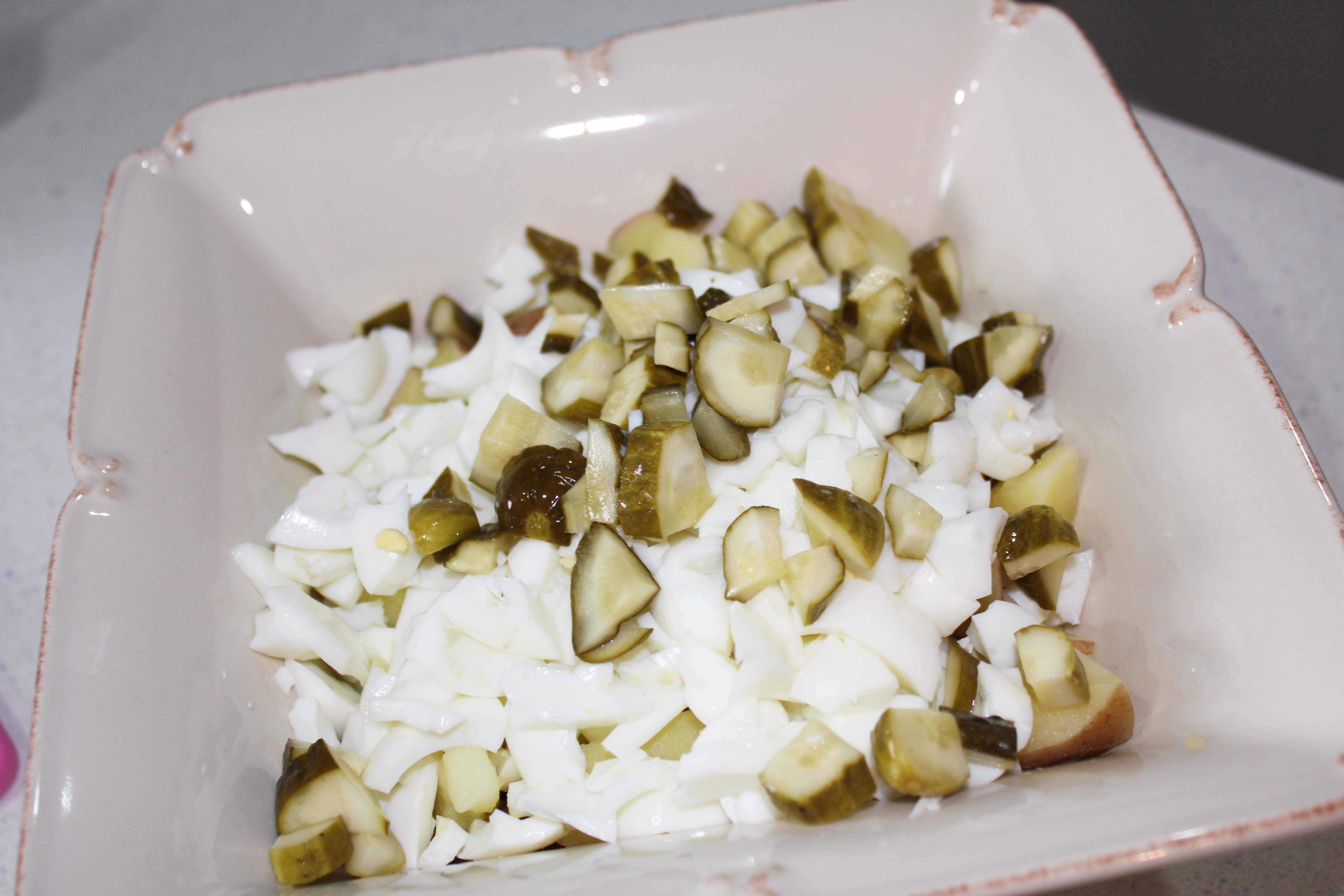 Chop the egg whites and pickles then add to cooked, drained and cooled potatoes.