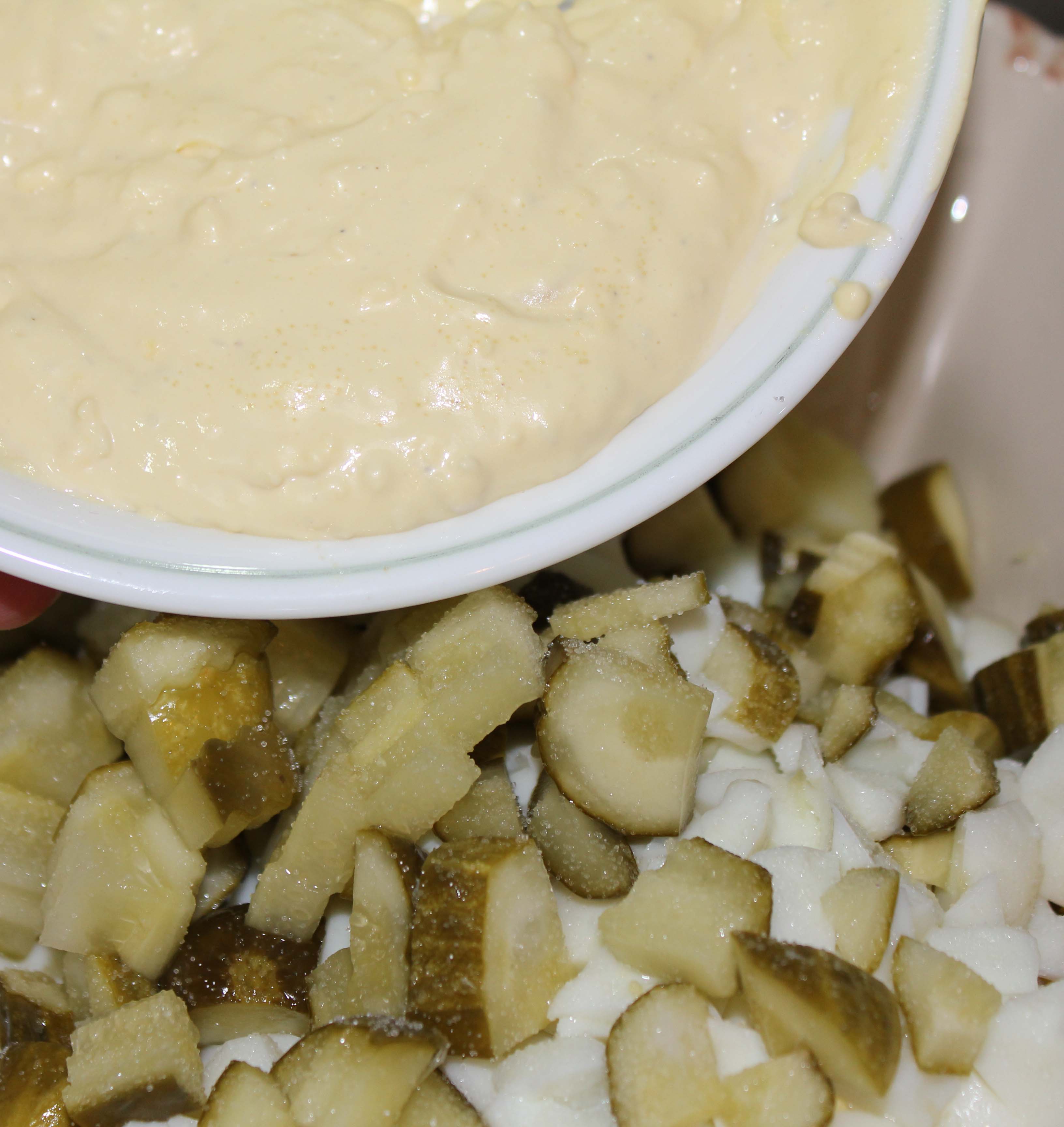 Spoon the dressing, made from the smashed yolks, over the top of the chunky mixture. Blend well.