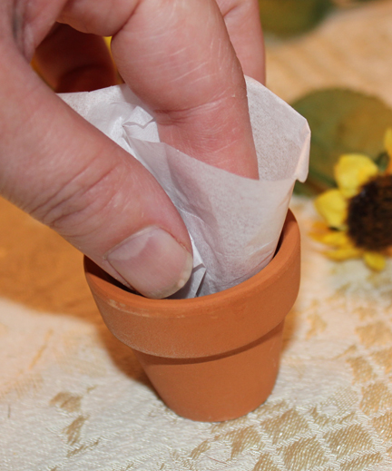 Wrap around your index finger and stuff into the pot, fluffing out the edges.